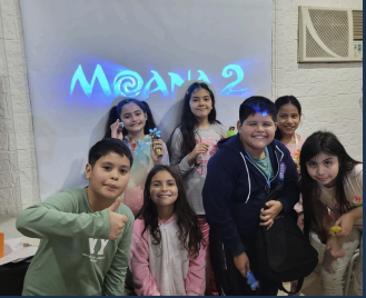 Group of children smiling together during an in-person cultural activity at the center.